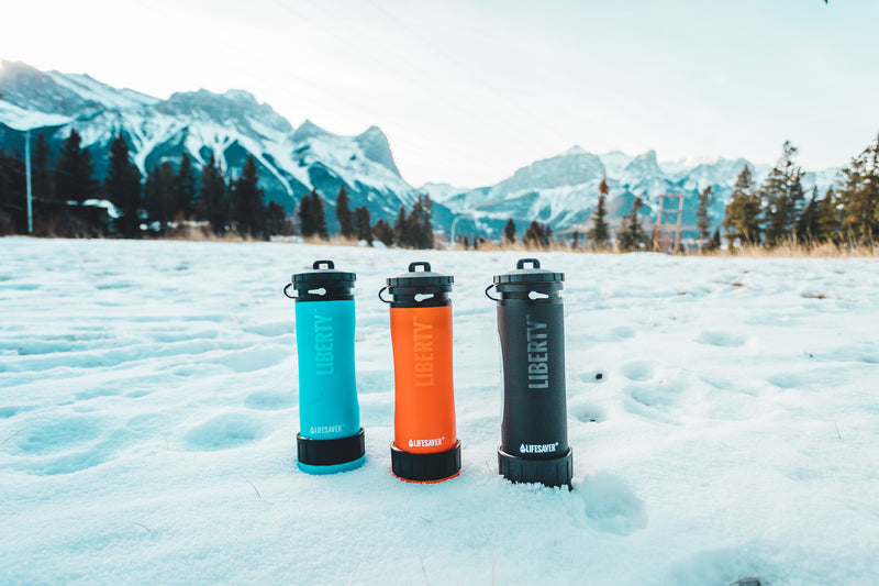Load image into Gallery viewer, Liberty water bottles in a snowy mountainside
